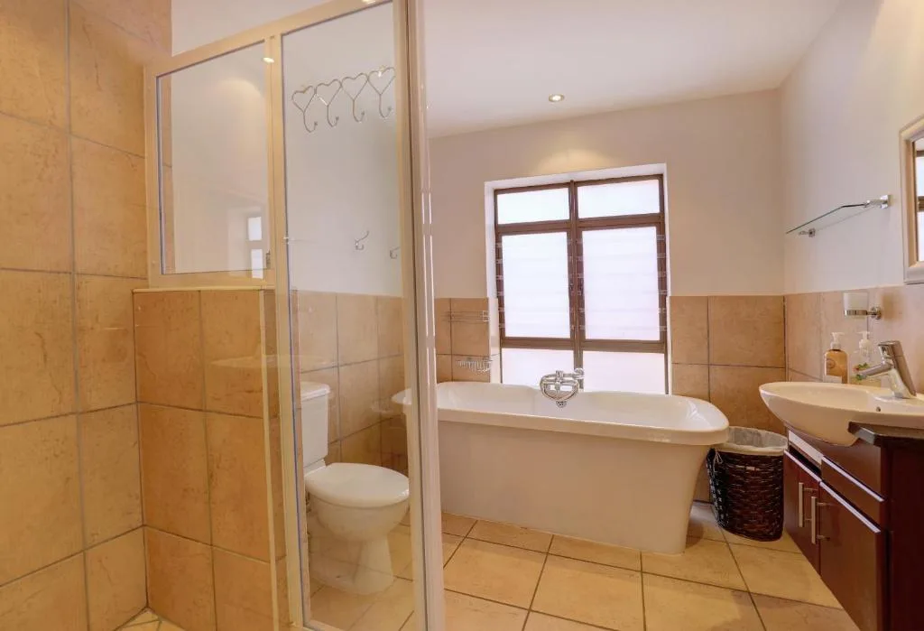 Spacious bathroom with freestanding tub, walk-in shower, and vanity