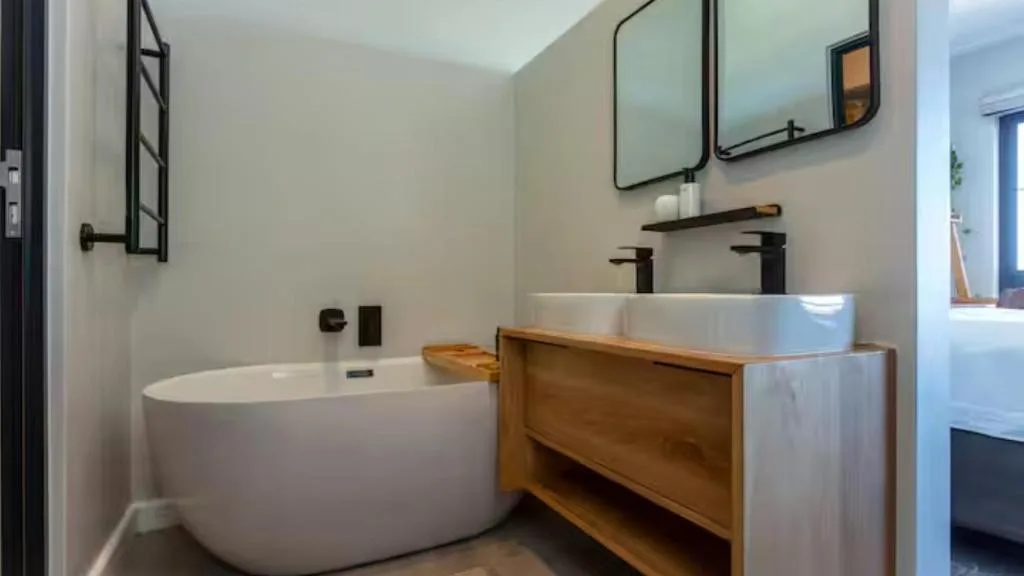Modern bathroom with freestanding bath and wooden vanity sink