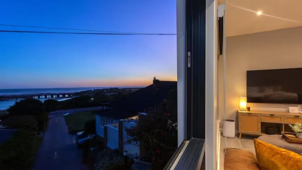 Twilight coastal vista with lagoon and mountains from property deck
