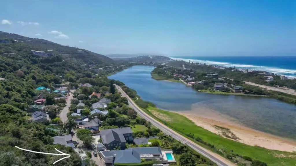Aerial view of lagoon, beach, and coastal properties on Garden Route