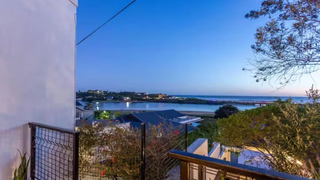 Twilight lagoon and coastal town view from elevated property deck