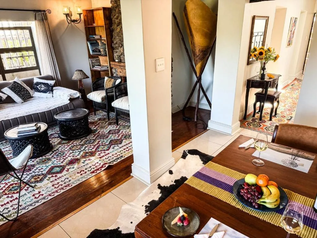 Dining table with fresh fruit and place settings overlooking bedroom area