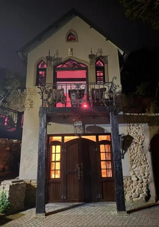 Charming white building facade with arched windows lit at night