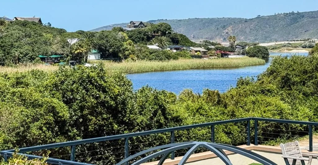 Lagoon and river views from deck with lush vegetation and mountains