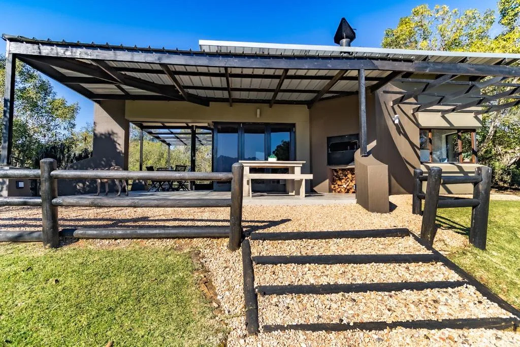 Modern covered patio with pergola, wooden railings, and outdoor seating area