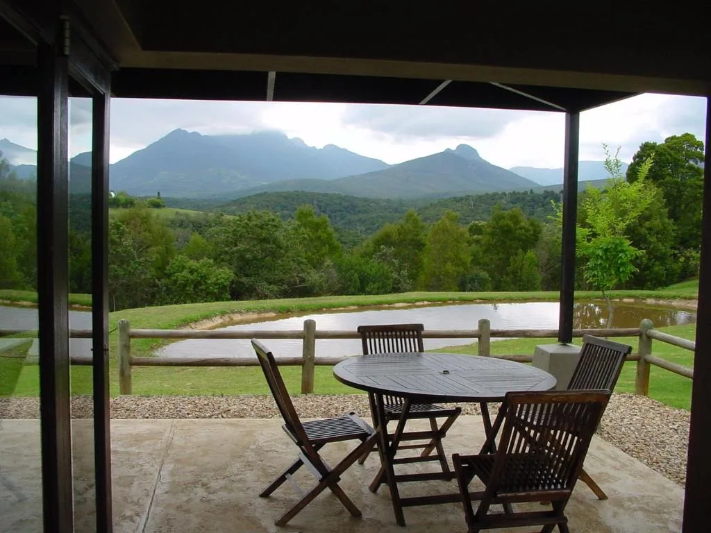 Mountain vista and lush valley landscape viewed from covered patio seating area