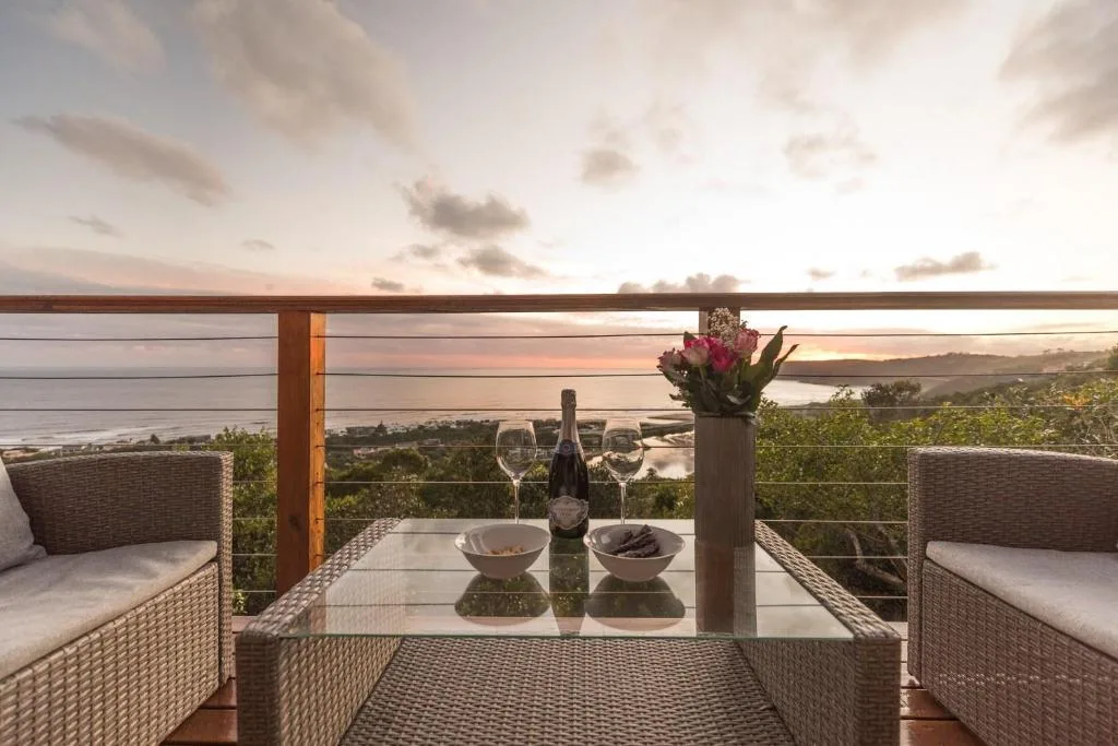 Scenic lagoon and mountain views from elevated deck with wine service