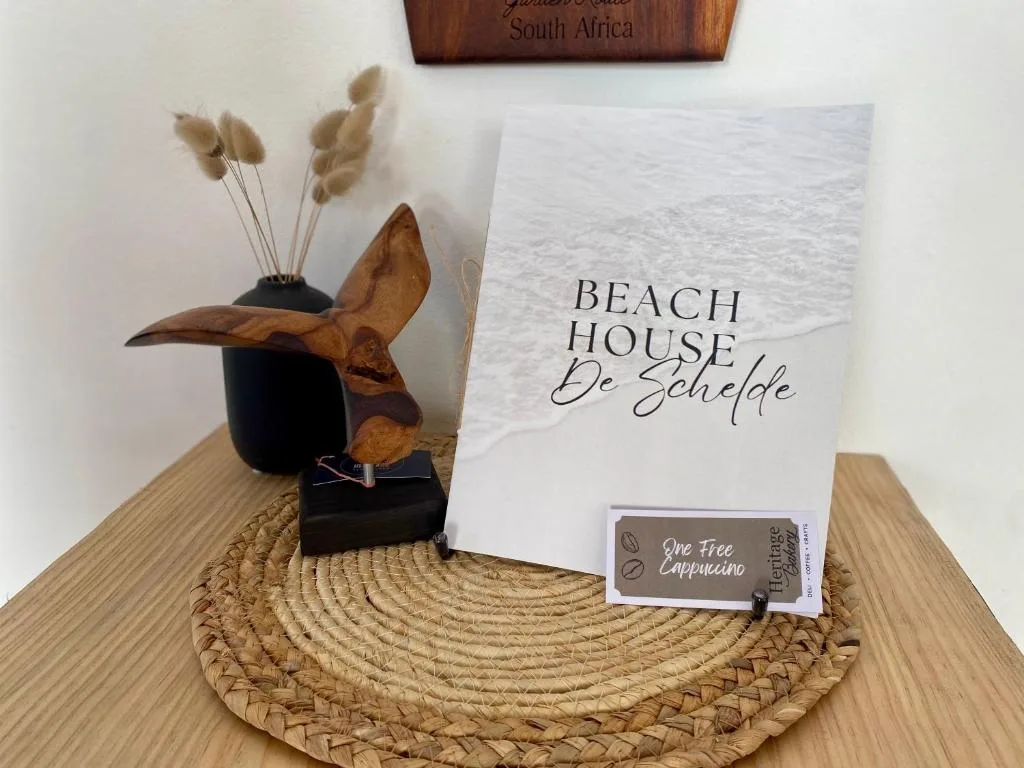 Welcome display with beach house signage and decorative coastal accents