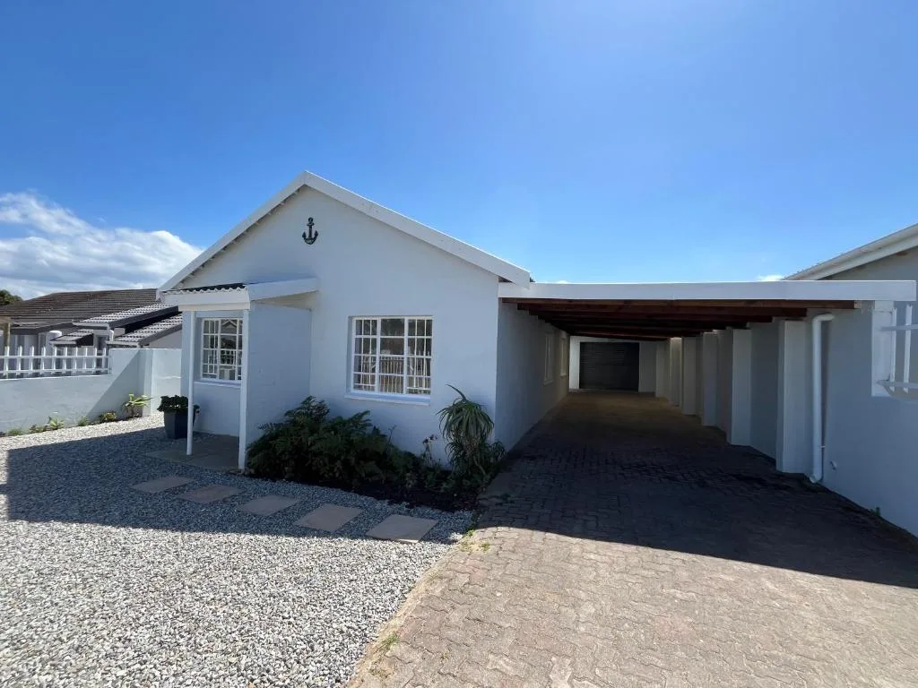 White beach cottage with carport and anchor decoration, Garden Route property