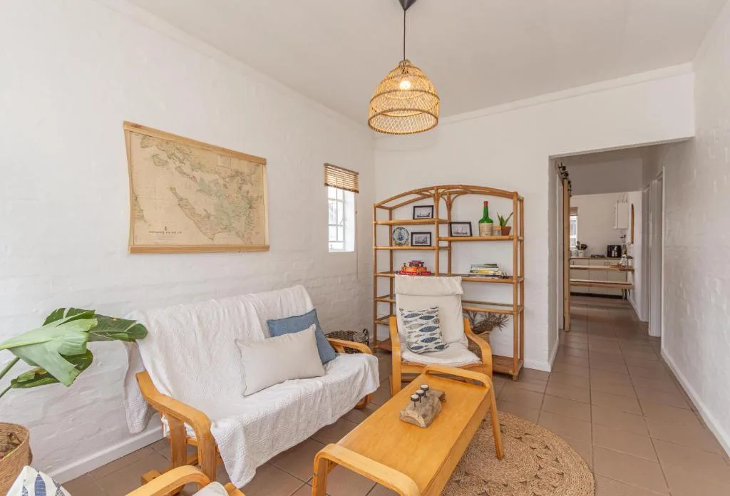 Bright living room with wooden furniture, sofa, and coastal decor elements