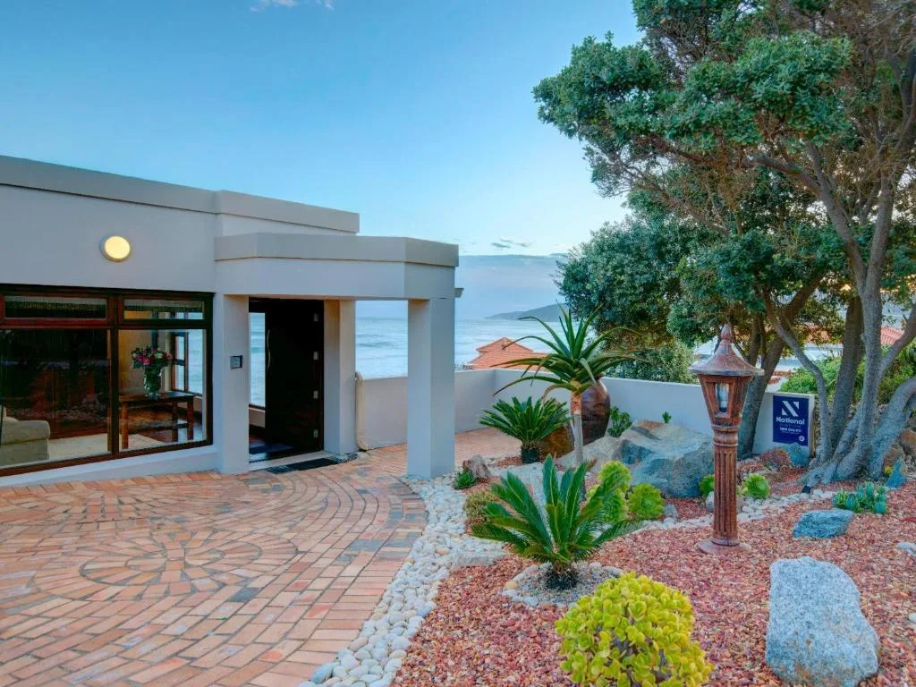 Modern beachfront home with ocean view and landscaped garden entrance