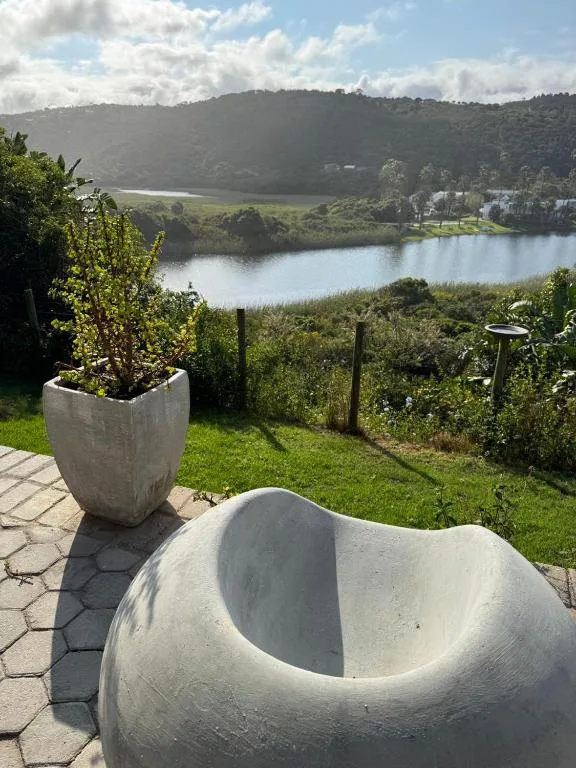 Scenic lagoon view with mountains and tree-lined banks from property deck