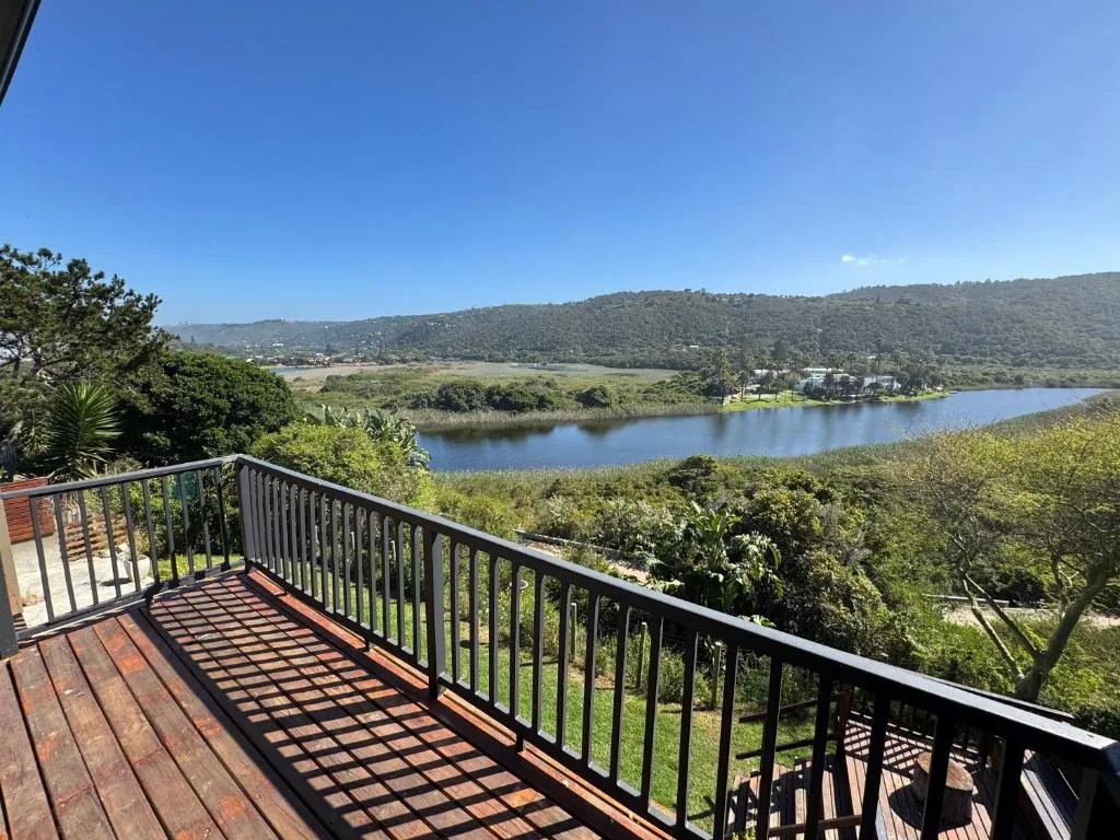 Scenic lagoon view with mountains and lush vegetation from deck