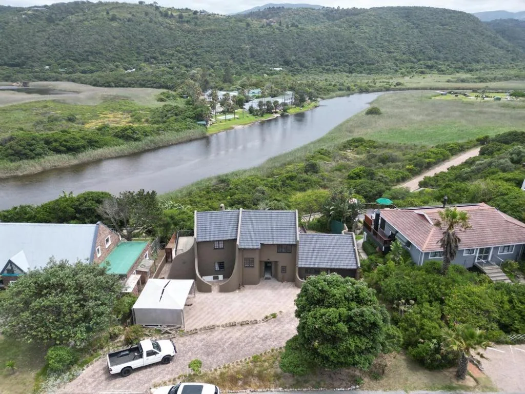 Scenic river valley with lush green hills and distant mountains backdrop