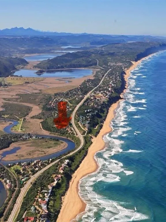 Aerial view of Wilderness coastline with golden beach, river mouth, and mountains