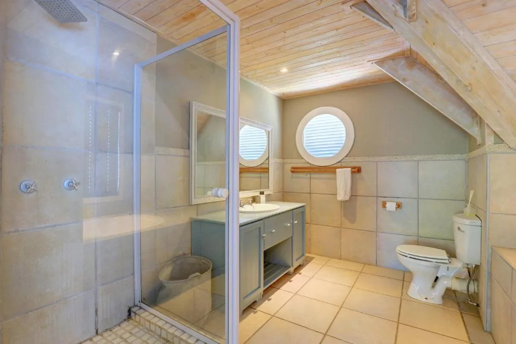 Spacious bathroom with shower enclosure, vanity sink, and toilet