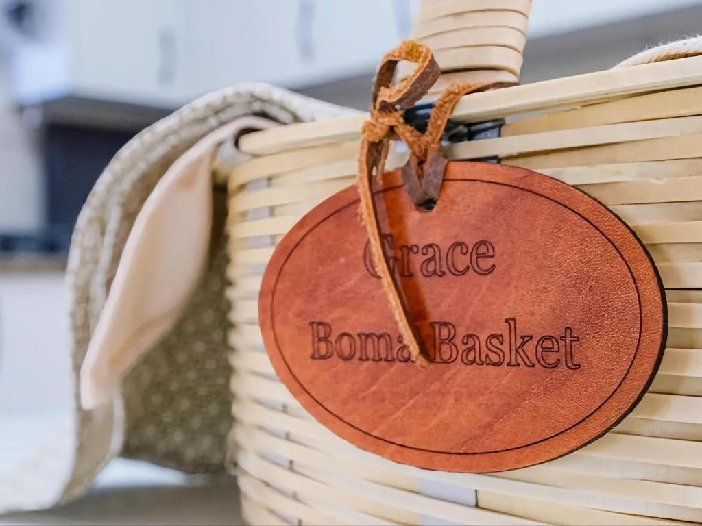 Leather name tag hanging from woven basket detail at accommodation