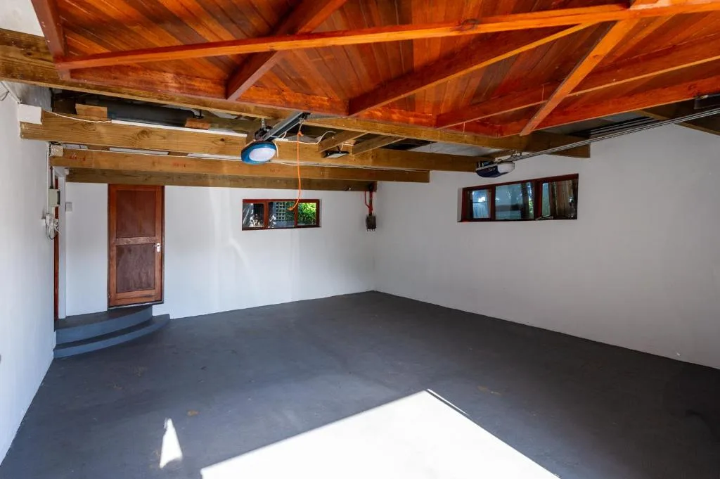 Interior space with exposed wooden beams and polished concrete flooring