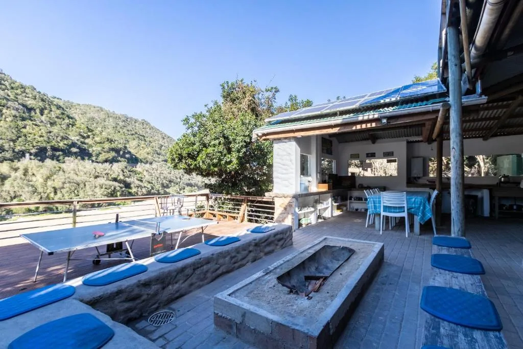 Expansive wooden deck with fire pit, table tennis, and mountain views