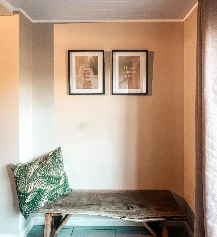 Cozy nook with wooden bench, tropical pillow, and inspirational wall art