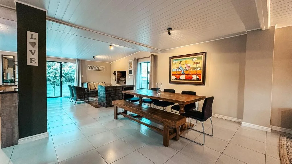Open-plan dining area with wooden table and bench seating for guests