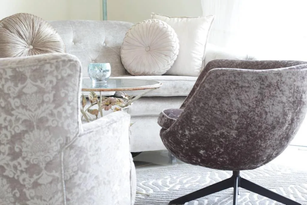 Comfortable lounge area with upholstered chairs and decorative pillows