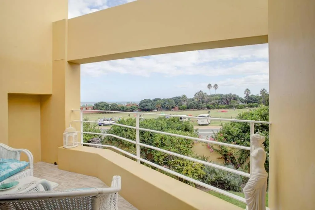 Scenic landscape view from balcony over green fields and distant mountains