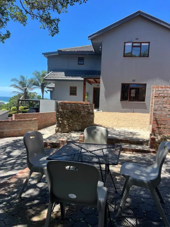 Modern two-story house with outdoor seating area and ocean view