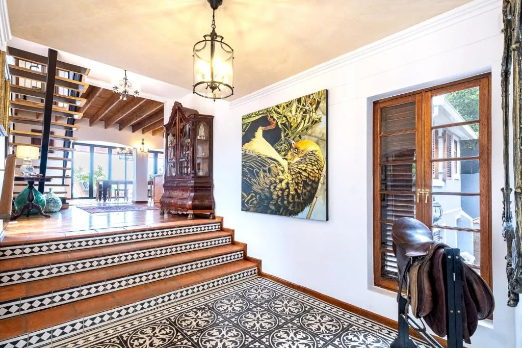 Elegant entrance hallway with decorative tile flooring and wooden stairs
