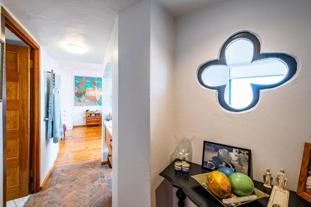 Decorative cloud-shaped window with artistic decor and wooden door entrance