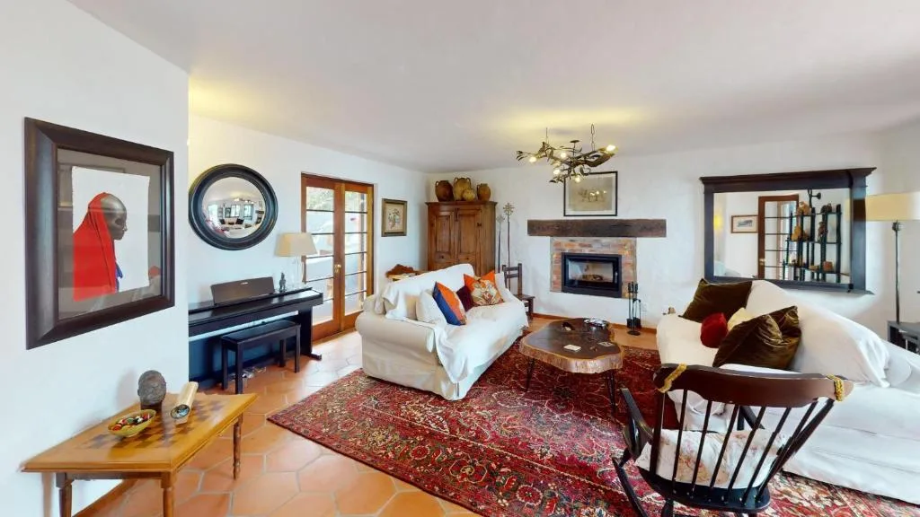 Spacious lounge with fireplace, comfortable seating, and decorative artwork