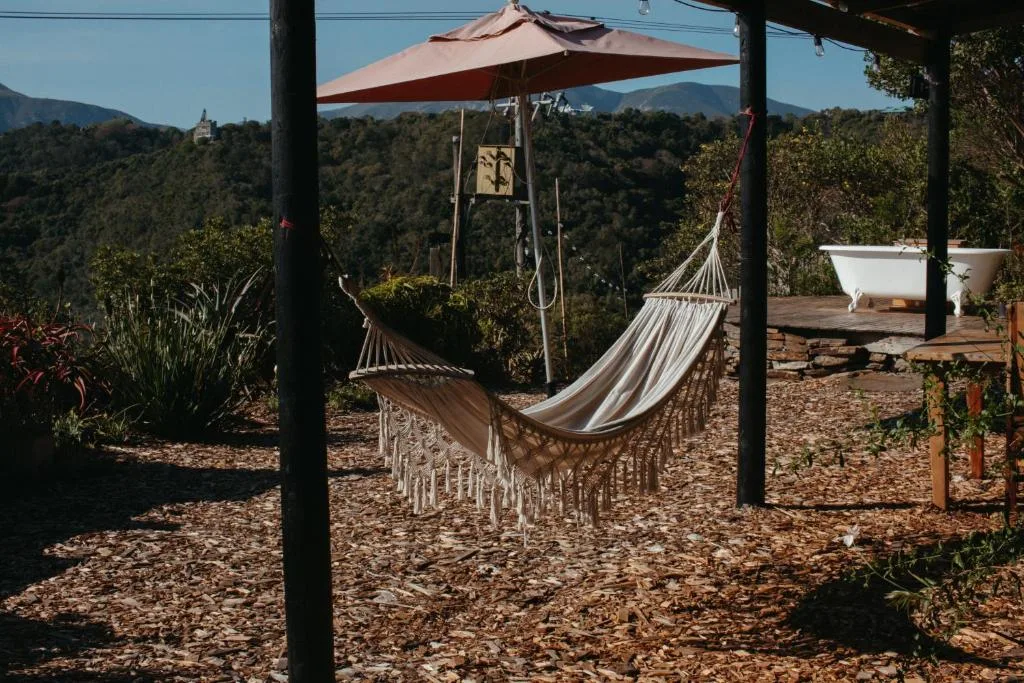 Outdoor deck with hammock, umbrella, and mountain views