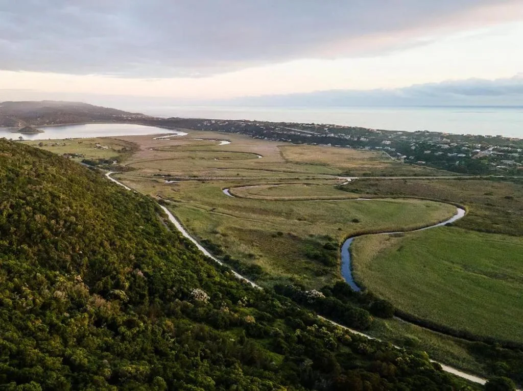 Aerial view of winding river, lagoon, and coastal settlement on Garden Route