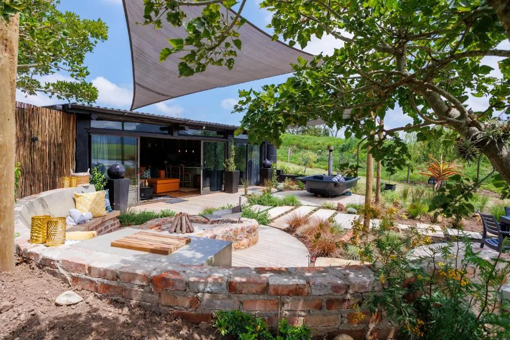 Outdoor deck with firepit, seating, and shaded patio area