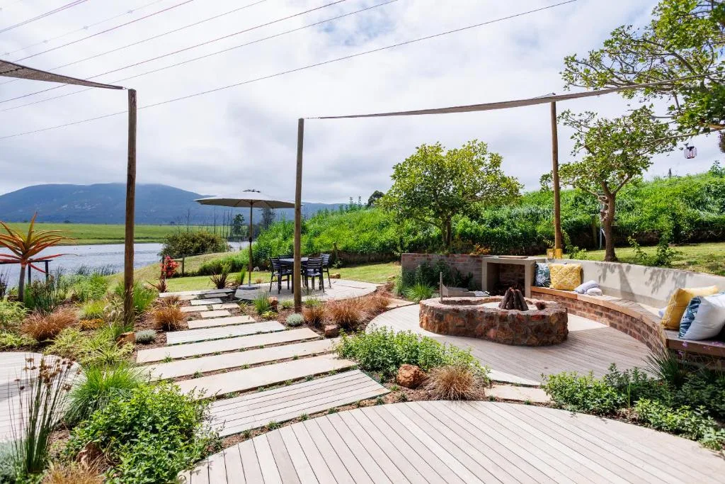 Spacious outdoor deck with fire pit, seating, and mountain lagoon views
