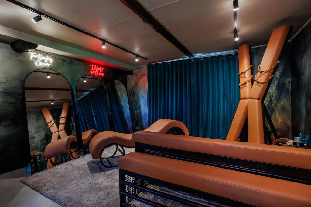 Modern themed indoor space with orange sculptural elements and blue curtains