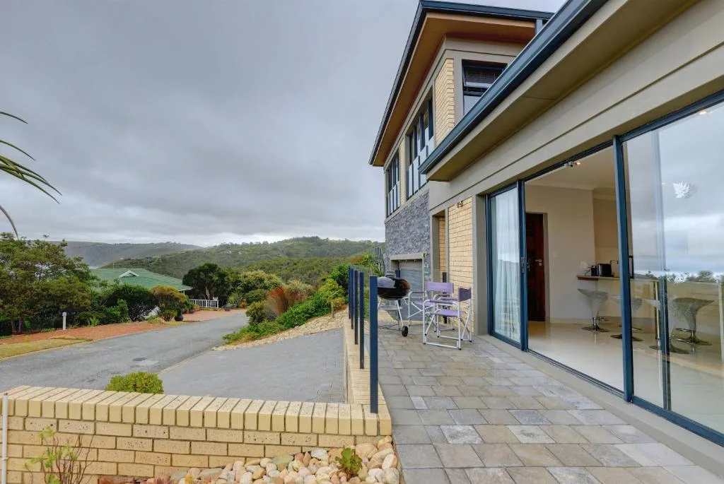 Spacious paved patio with outdoor seating overlooking lush valley landscape