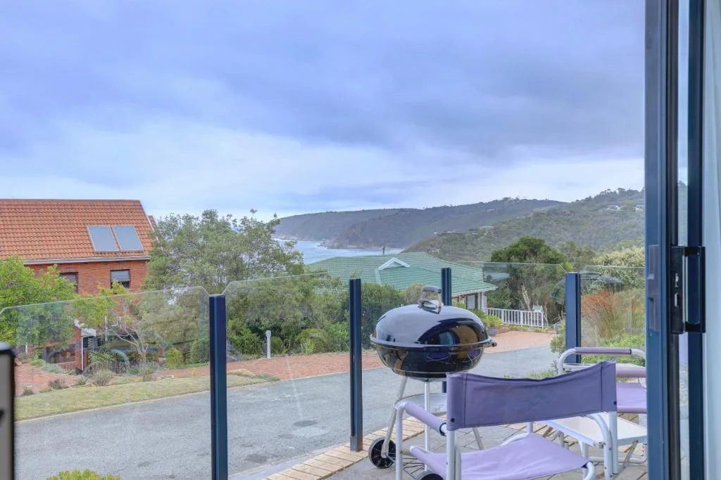 Scenic coastal view with mountains and bay visible from deck area