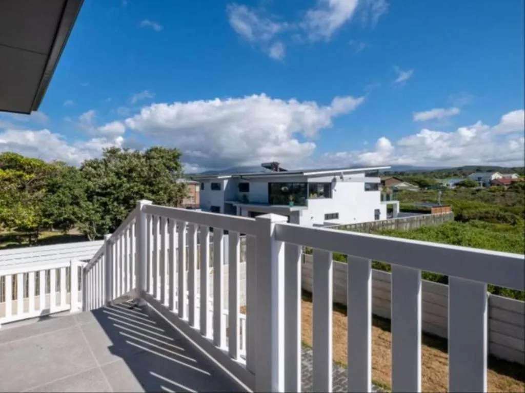 Modern white railing balcony with panoramic countryside and mountain views