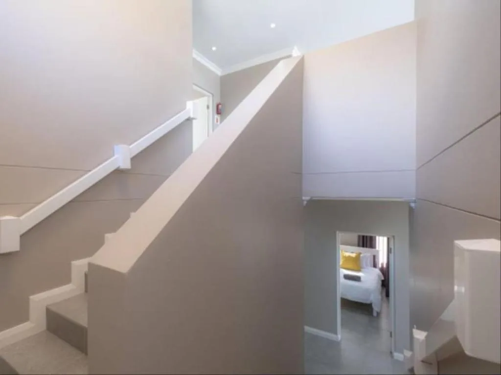 Modern interior staircase with white railings and minimalist design elements