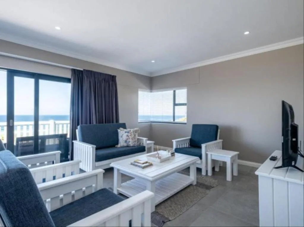 Bright lounge with ocean view, blue furniture, and coastal decor