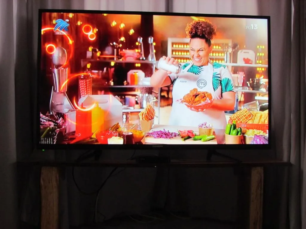 Television mounted in lounge area displaying entertainment content