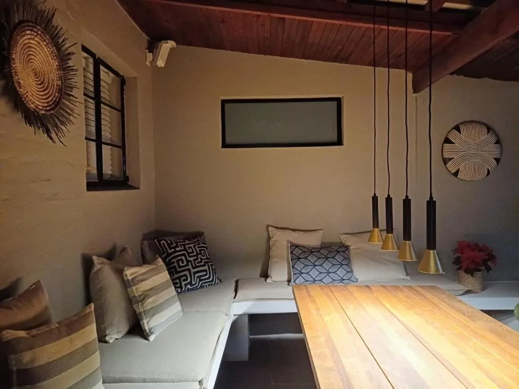 Modern bedroom with pendant lights, decorative wall art, and patterned pillows