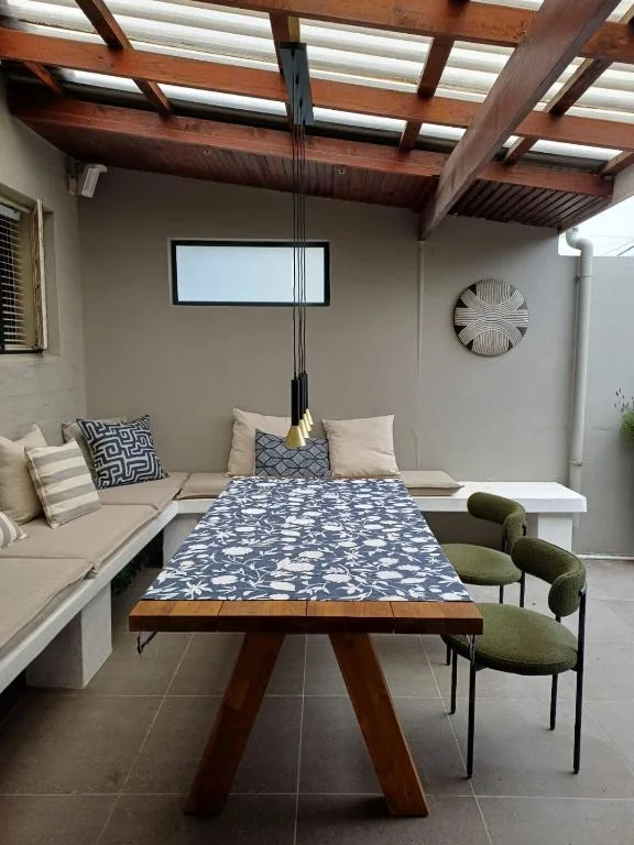 Modern dining table with patterned runner in open-plan living space