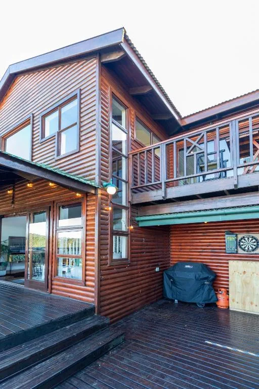 Modern wooden chalet with wraparound deck and ocean view positioning