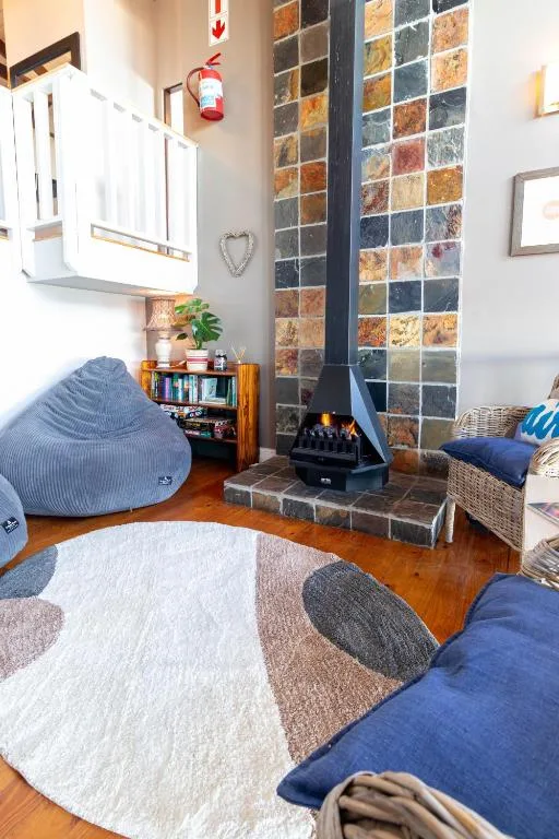 Cozy living room with fireplace, bean bags, and geometric patterned rug