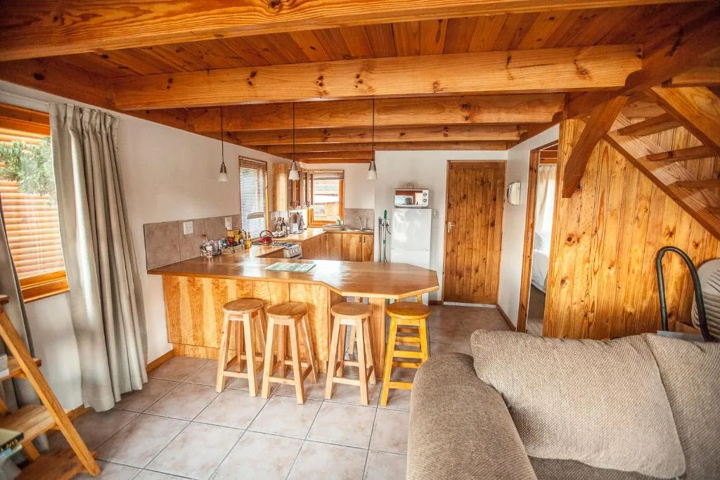 Spacious wooden kitchen with island seating and modern appliances