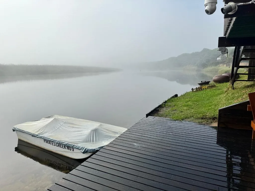 Misty lake view from wooden deck with moored boat
