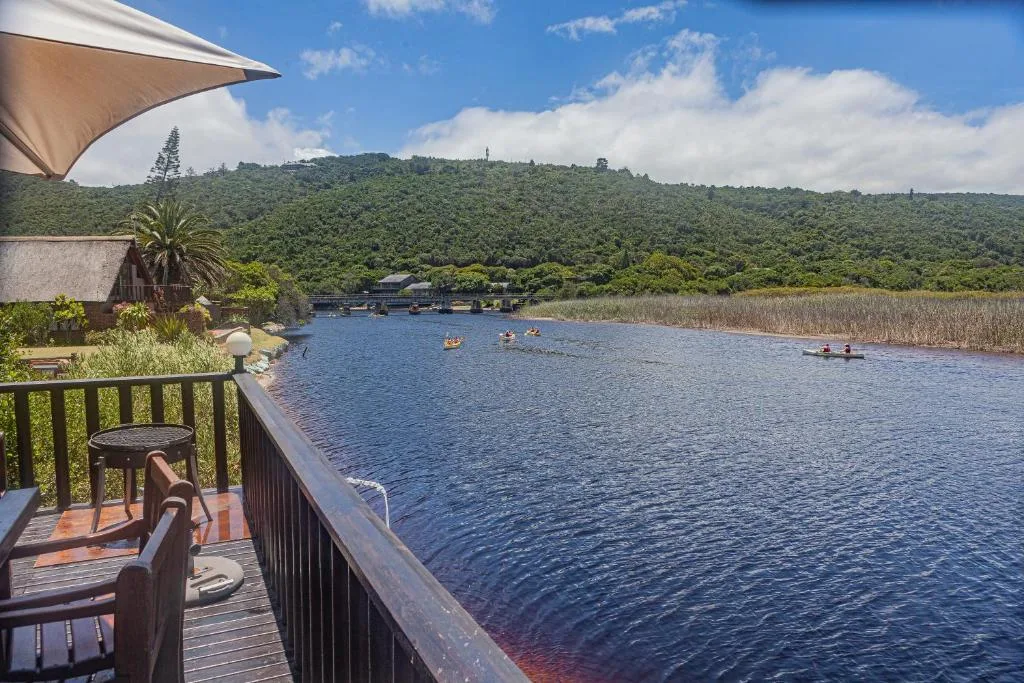 Scenic lagoon view with mountains, reeds, and water activities visible