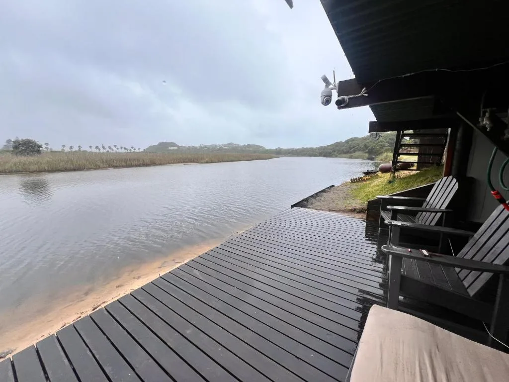 Lagoon waterfront view with reeds and distant hills from deck
